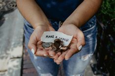 Hands holding out coins and a note saying Make a change